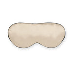 Caramel-colored silk sleep mask with black trim