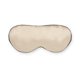 Caramel-colored silk sleep mask with black trim